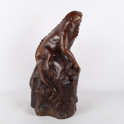 146 - A large carved hardwood study of a iguana climbing a tree stump, H56cm