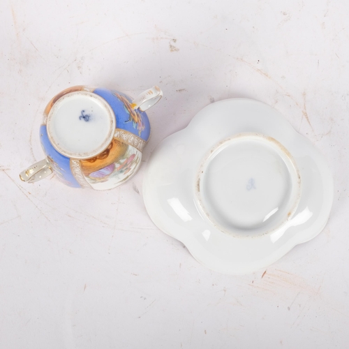 165 - An Antique Dresden quatrefoil 2-handled cup and saucer, painted blue and white panels decorated with... 