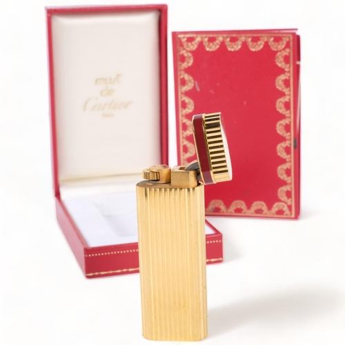 174 - A Must De Cartier, Paris, gold plated briquet lighter, H7cm, serial no. 06098, complete with box cer... 