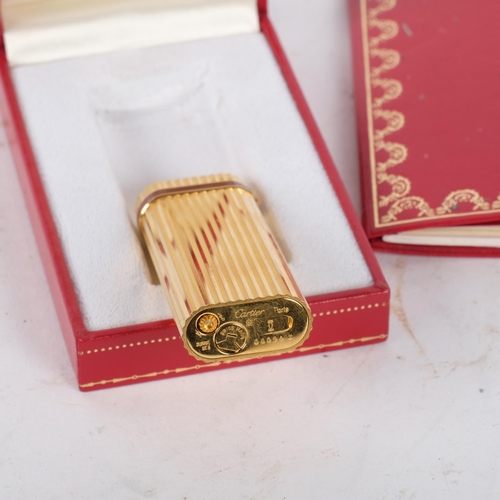 174 - A Must De Cartier, Paris, gold plated briquet lighter, H7cm, serial no. 06098, complete with box cer... 