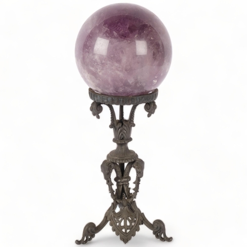 194 - A large amethyst spherical ball, on decorative wrought-iron stand, H33cm