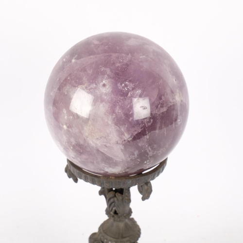 194 - A large amethyst spherical ball, on decorative wrought-iron stand, H33cm