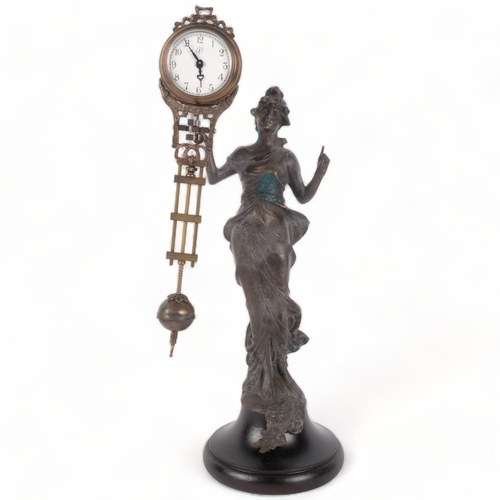 197 - An Art Deco style mystery clock, surmounted by a figure, H34cm