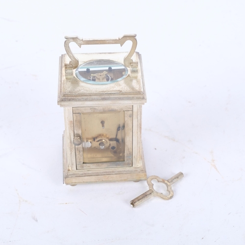 203 - A miniature silver plated carriage clock, with enamel dial, and key, height not including handle 8cm... 