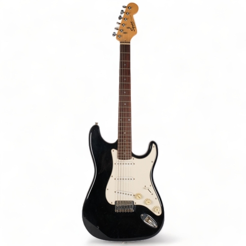 224 - A Squire Strat by Fender electric guitar, black body, no serial no.