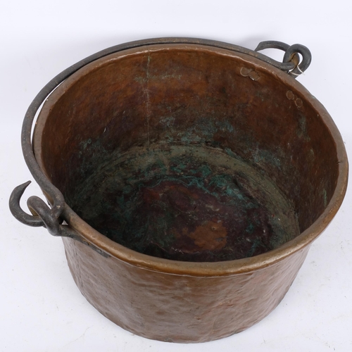 260 - A large Antique copper cauldron, with cast-iron hooks and handle, H28cm, D49cm