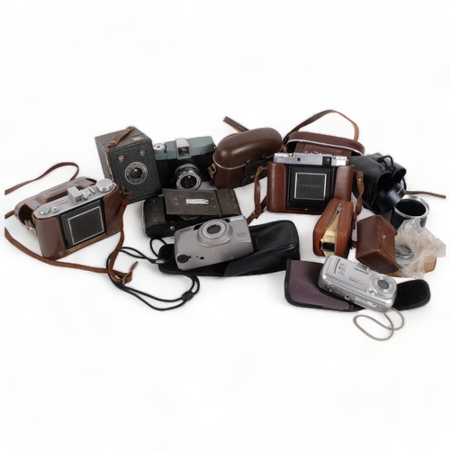 264 - A quantity of Vintage cameras and associated items, including a Zeiss Ikon Super Ikonta, an Olympus ... 