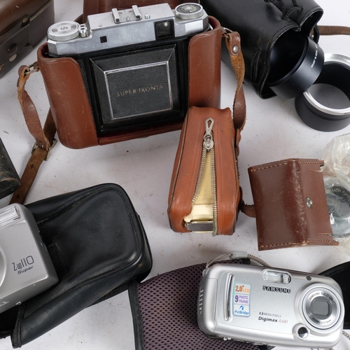 264 - A quantity of Vintage cameras and associated items, including a Zeiss Ikon Super Ikonta, an Olympus ... 