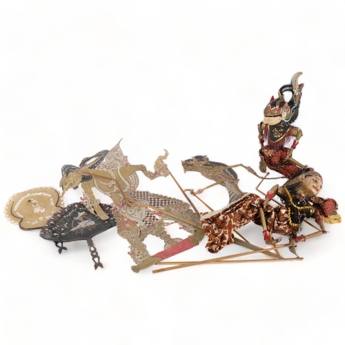 271 - A group of Vintage Oriental shadow puppets, with associated fans depicting shadow puppets