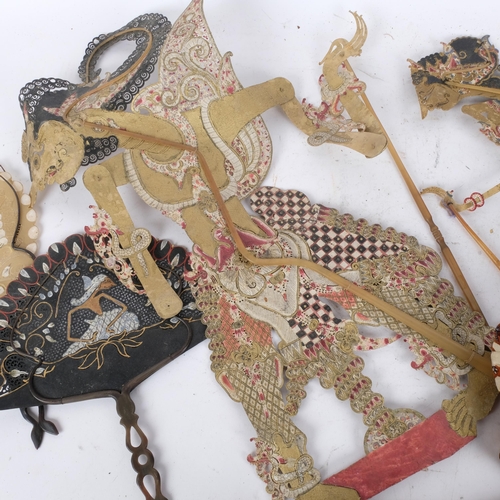 271 - A group of Vintage Oriental shadow puppets, with associated fans depicting shadow puppets