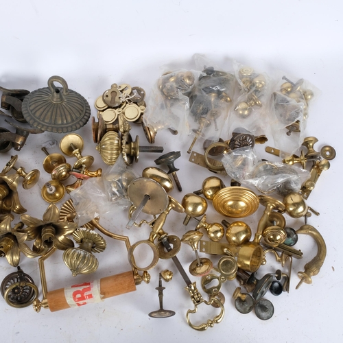 277 - A box of brass casters, door handles, light fittings etc