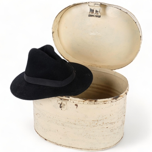 278 - A Vintage hat tin, 37cm across, containing a black hat