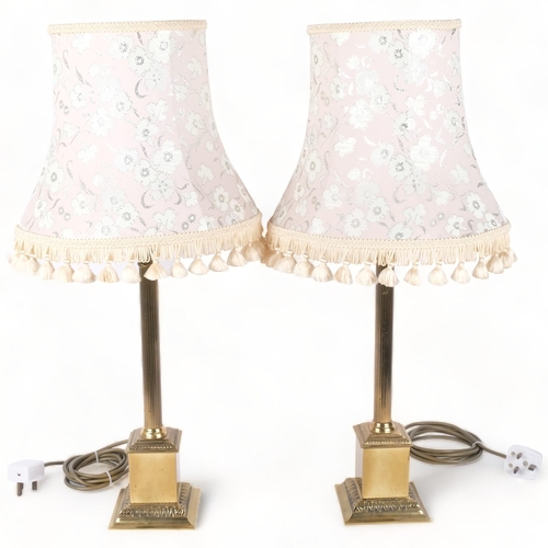 340 - A pair of Classical design cast-brass table lamps with reeded columns, and matching cream shades, H6... 