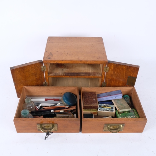 344 - Vintage oak table-top 2-drawer cabinet, with inset brass handles, containing various stationery item... 