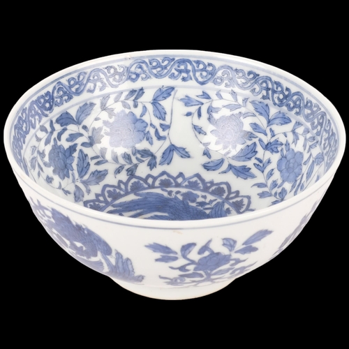 384 - A blue and white Chinese porcelain bowl, with bird and floral design and 6 character mark, 15cm diam... 