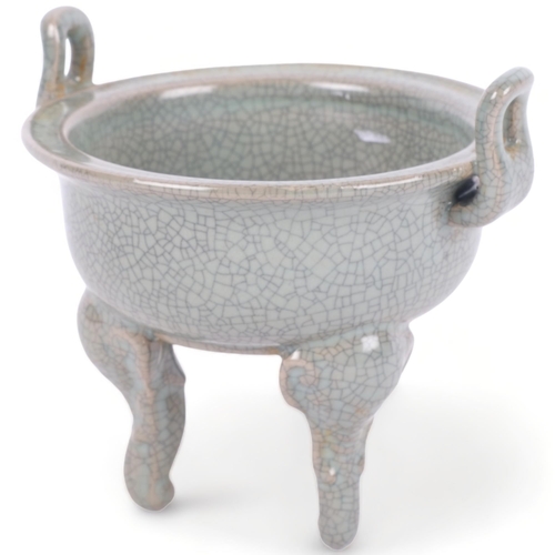 386 - A Chinese celadon crackle glaze censer, on tripod support, 11.5cm across