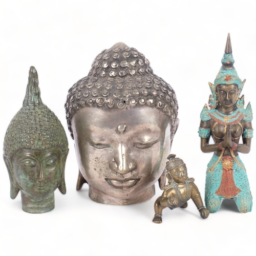 392 - A verdigris bronze Buddha's head, 15cm, a silver plated Buddha's head, and 2 other figures