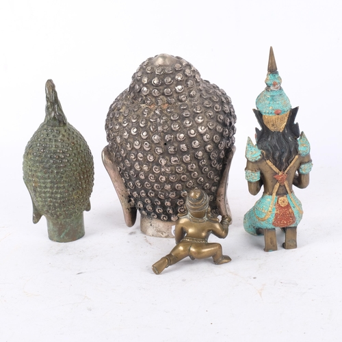 392 - A verdigris bronze Buddha's head, 15cm, a silver plated Buddha's head, and 2 other figures