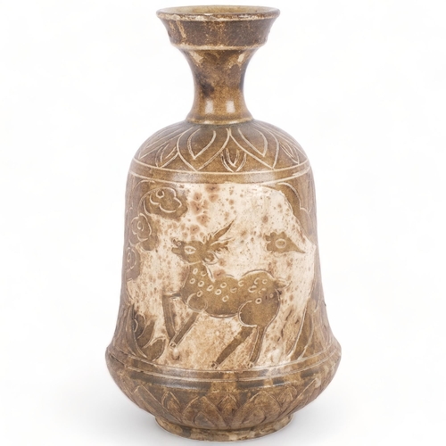 394 - An Oriental pottery vase, with incised and glazed design of deer, 26cm