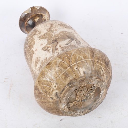 394 - An Oriental pottery vase, with incised and glazed design of deer, 26cm