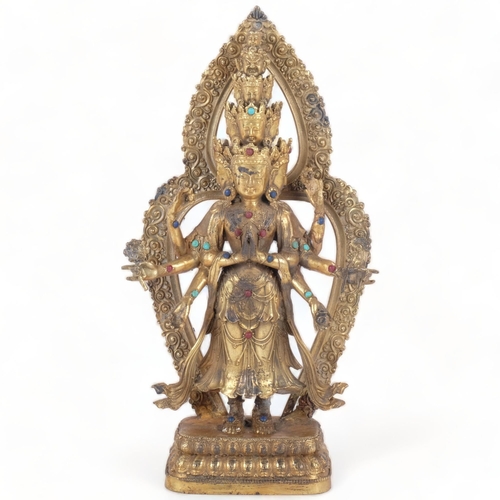 400 - A gilt-bronze multi-faced Buddha figure, inset with jewels, on lotus base, H27cm