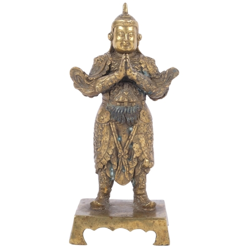 401 - An embossed cast-bronze Buddha figure, on rectangular stand, 23.5cm