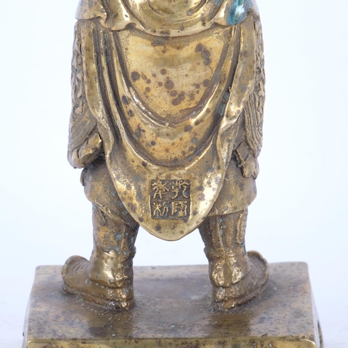 401 - An embossed cast-bronze Buddha figure, on rectangular stand, 23.5cm