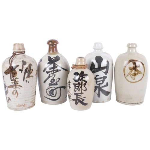 410 - 5 various Japanese Sake bottles with inscriptions, 26.5cm