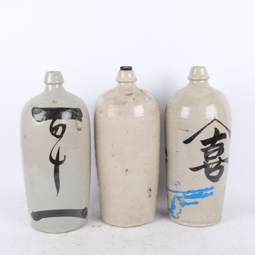 411 - 3 ceramic Japanese Sake bottles with inscriptions, 35.5cm