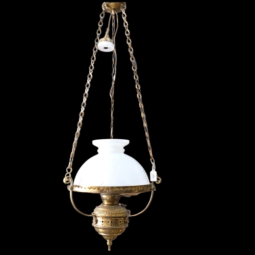 423 - A brass oil lamp style electric light, with milk glass shade and chains, 35cm across