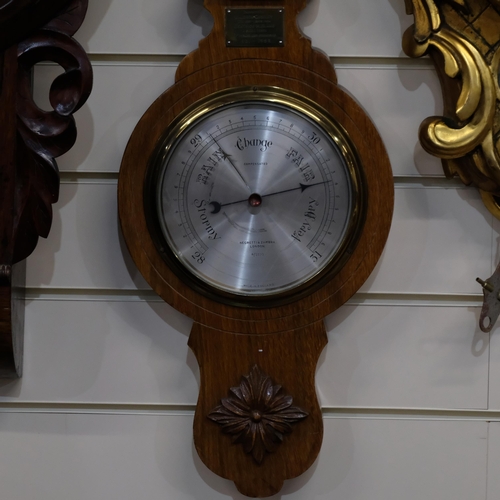 442 - A Negretti & Zambra aneroid barometer, in carved oak case, with presentation plaque for 1952, 74cm