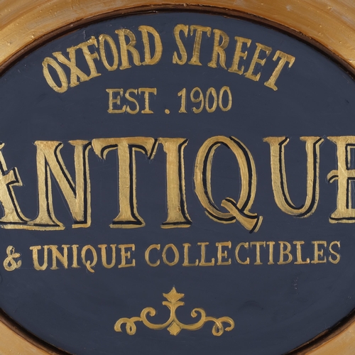 478 - Clive Fredriksson, an oval painted and gilded sign, Antique and Unique Collectables, Oxford Street, ... 