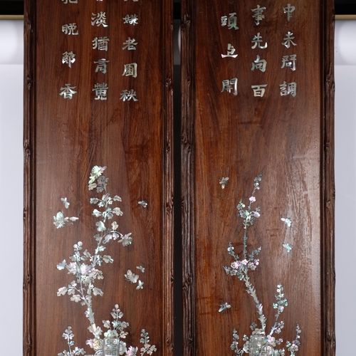 481 - A pair of Oriental hardwood panels, with inset mother-of-pearl script and blossom tree decoration, 1... 