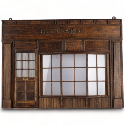 490 - A wall-hanging stained wood ornamental shop front, with glazed window and door panels 