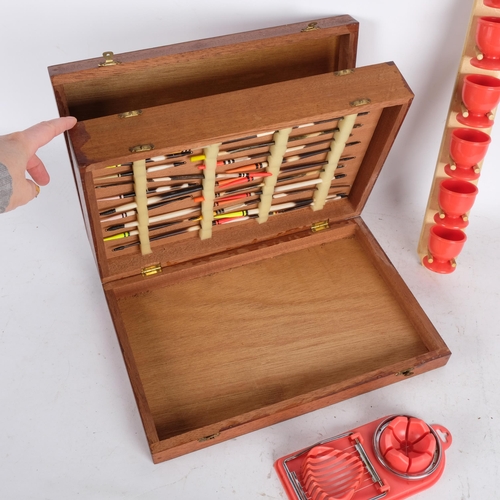 496 - Vintage plastic egg cups and holder, an egg slicer, and a wooden box of fishing lures