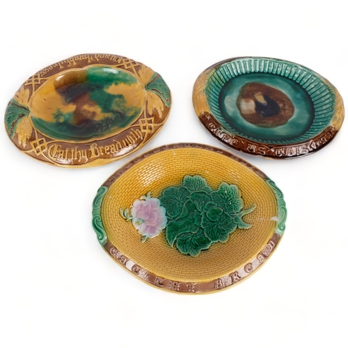 62 - 3 Majolica bread plates, all with embossed script including Eat my bread with joy and thankfulness, ... 