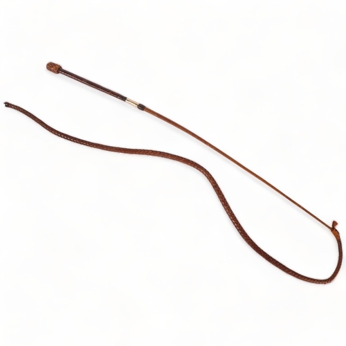 68 - An Antique leather riding whip, with an engraved 15ct gold band