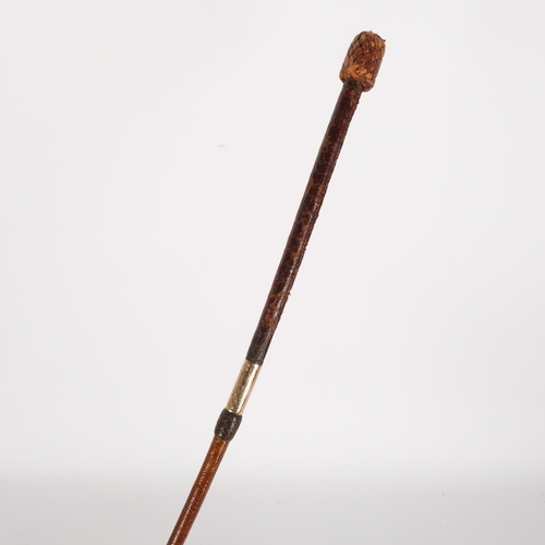 68 - An Antique leather riding whip, with an engraved 15ct gold band