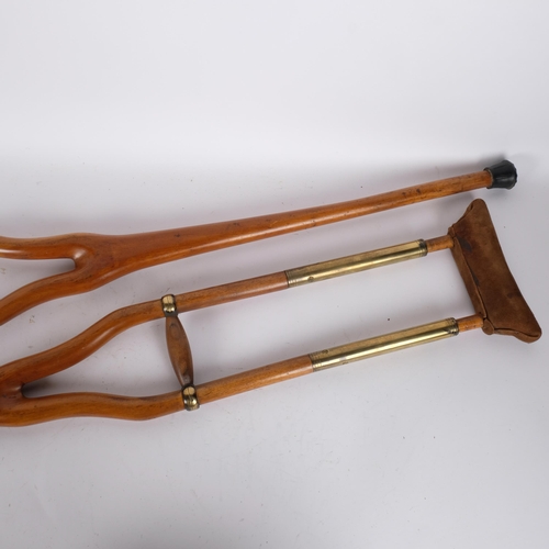 71 - A pair of vintage brass mounted crutches, with sprung leather supports. H - 115cm.