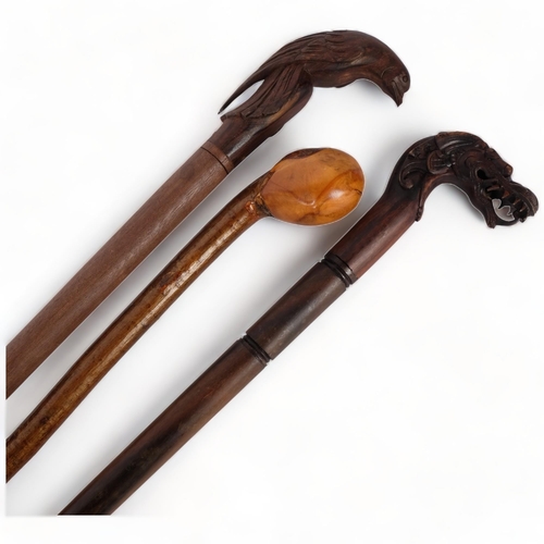 78 - 3 various turned wood walking canes, 1 with a carved dragon handle, another with a bird carved handl... 