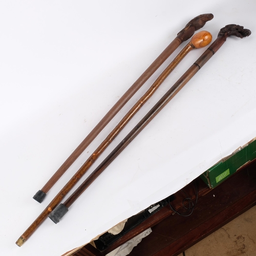 78 - 3 various turned wood walking canes, 1 with a carved dragon handle, another with a bird carved handl... 