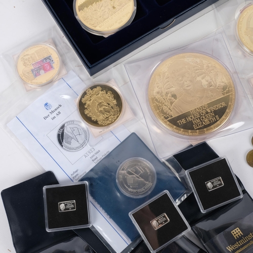 89 - A collection of commemorative coins and medallions, subjects to include Winston Churchill, Queen Eli... 