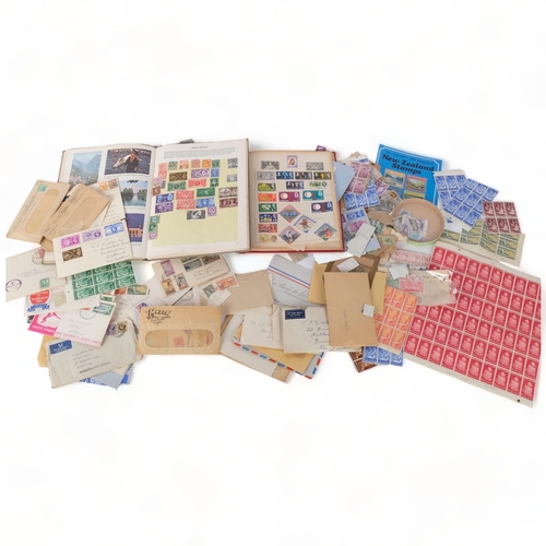 93 - A box of various loose worldwide stamps, and a stock book