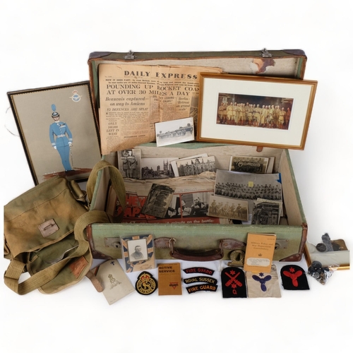 99 - A collection of military postcards, pictures, booklets, buttons, buckle, canvas bag, etc, in a leath... 