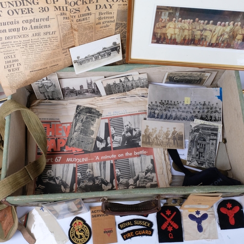 99 - A collection of military postcards, pictures, booklets, buttons, buckle, canvas bag, etc, in a leath... 