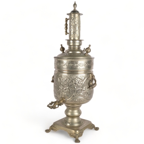 508 - A large engraved and embossed brass samovar, on plinth with lion paw feet, H82cm