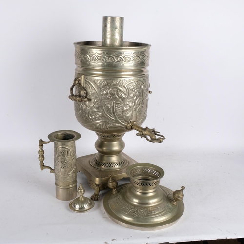 508 - A large engraved and embossed brass samovar, on plinth with lion paw feet, H82cm