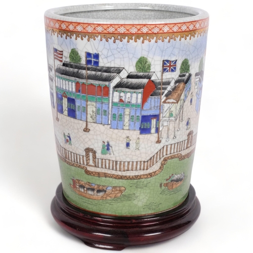 517 - A Japanese crackle glaze pot, with design of buildings, people and flags, H22cm, on wooden stand