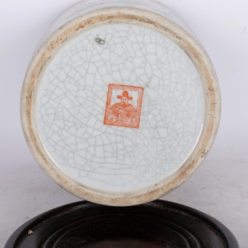 517 - A Japanese crackle glaze pot, with design of buildings, people and flags, H22cm, on wooden stand