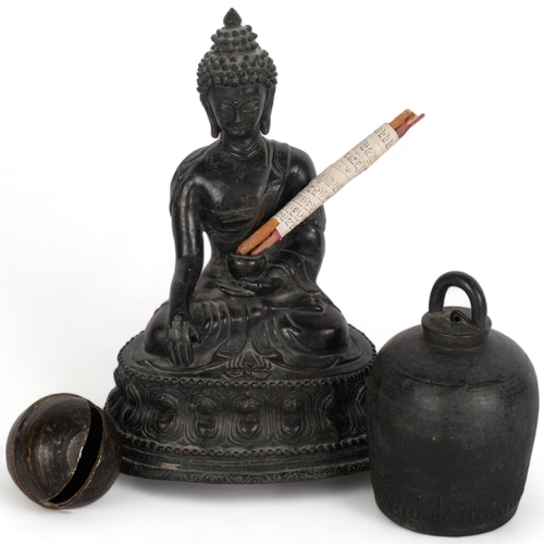 531 - An Oriental bronze Buddha, a temple bell, another, etc